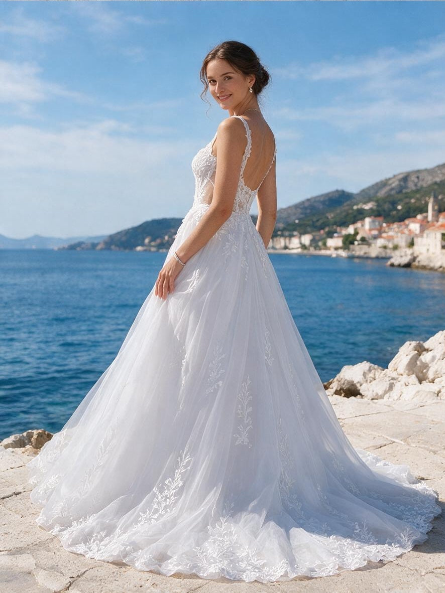 Lacey Bridal Ltd. Amalia A-line wedding gown with floral embroidery, sweetheart neckline, and tulle skirt by the sea.