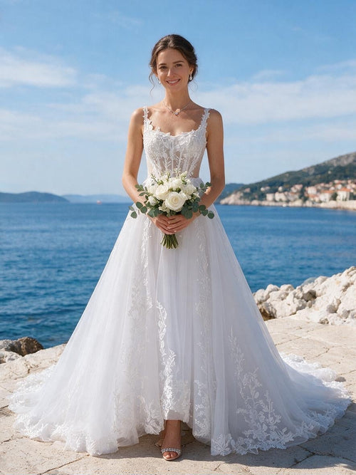 Lacey Bridal Ltd. Amalia A-line wedding gown with floral embroidery, sweetheart neckline, and tulle skirt by the sea.