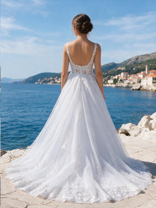 Lacey Bridal Ltd. Amalia A-line wedding gown with an open scoop back, floral embroidery, and a flowing tulle skirt.