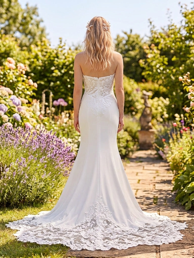 Lacey Bridal Ltd. Amarantha strapless crepe wedding gown with botanical lace back and scalloped chapel train in garden