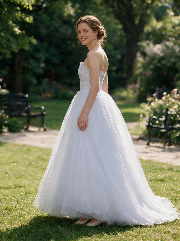 Lacey Bridal Ltd. Arabella strapless tulle wedding gown with floral lace bodice and corset back in a garden setting.