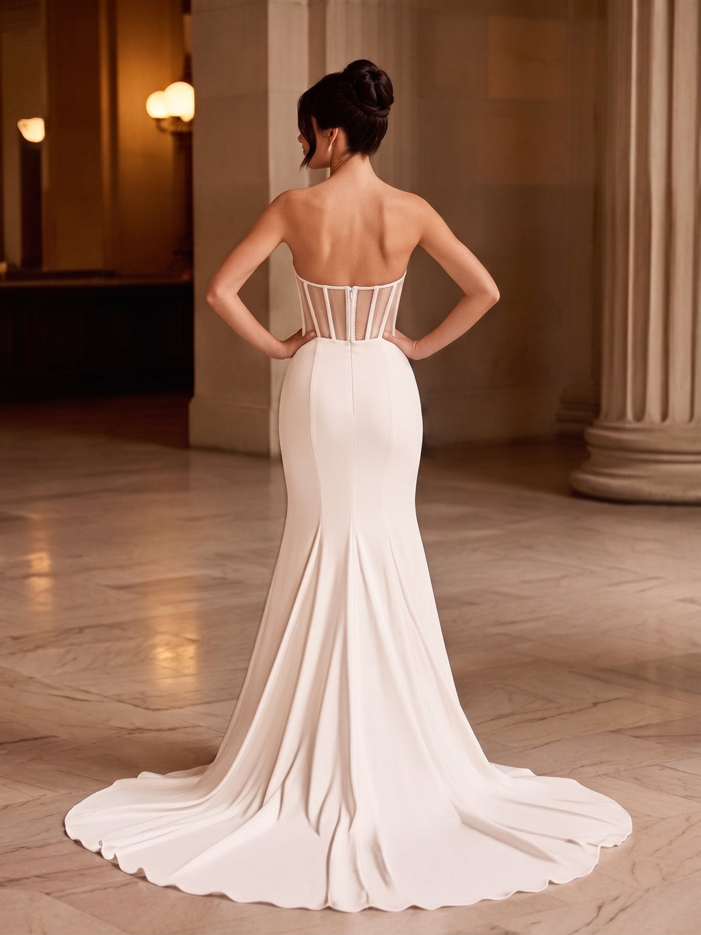 Back view of Lacey Bridal Ltd. Arielle mermaid wedding gown with illusion corset bodice and fluid crepe train.