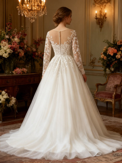 Lacey Bridal Ltd. ASTREA A-line wedding gown with long lace sleeves, illusion back, and button detailing on tulle skirt