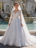 Lacey Bridal Ltd. Belinda A-line wedding gown with long illusion lace sleeves, floral appliqués, and tulle skirt.