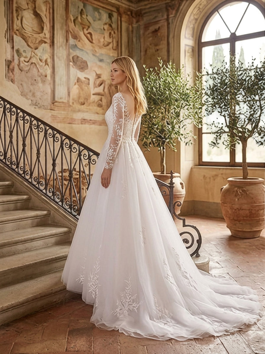 Lacey Bridal Ltd. Bianca A-line wedding gown with long illusion lace sleeves and a flowing tulle skirt in a villa.