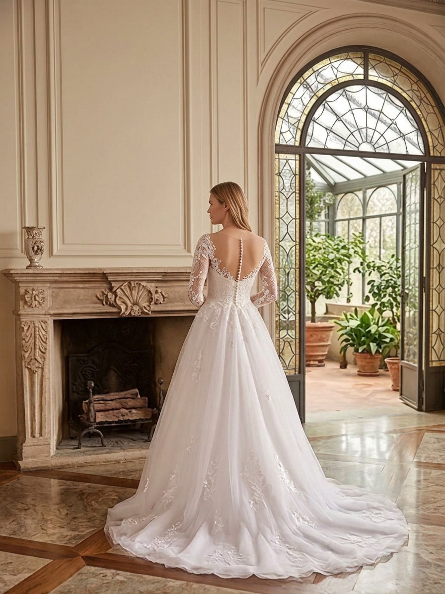 Lacey Bridal Ltd. Bianca A-line wedding gown with long illusion lace sleeves, button-back detail, and tulle skirt.