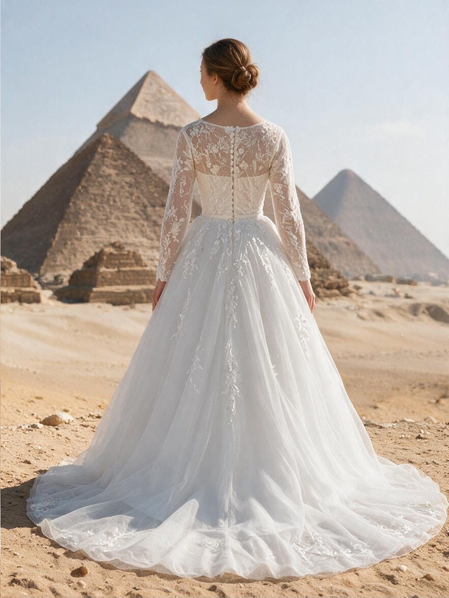 Lacey Bridal Ltd. Callista A-line wedding gown with long lace sleeves, illusion back, and tulle skirt in Egypt.