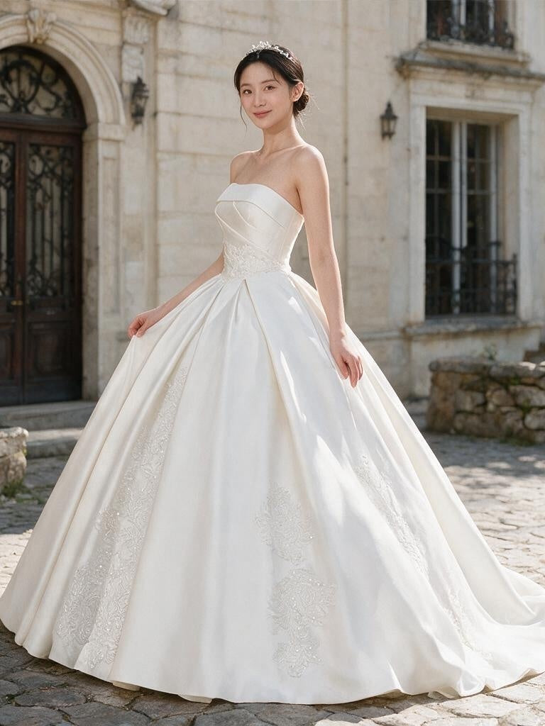 Lacey Bridal Ltd. CAROLINA strapless satin ballgown with architectural draping, lace insets, and a full pleated skirt.