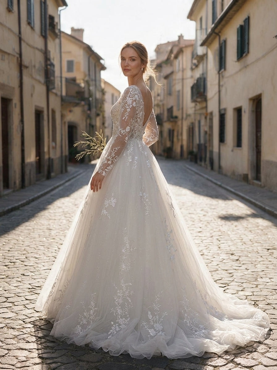 Lacey Bridal Ltd. Cassandra A-line wedding gown with floral embroidery, illusion sleeves, and a sweeping tulle train.