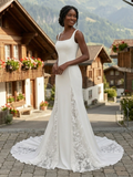 Lacey Bridal Ltd. Celeste crepe fit-and-flare wedding gown with square neckline and lace illusion skirt godets.