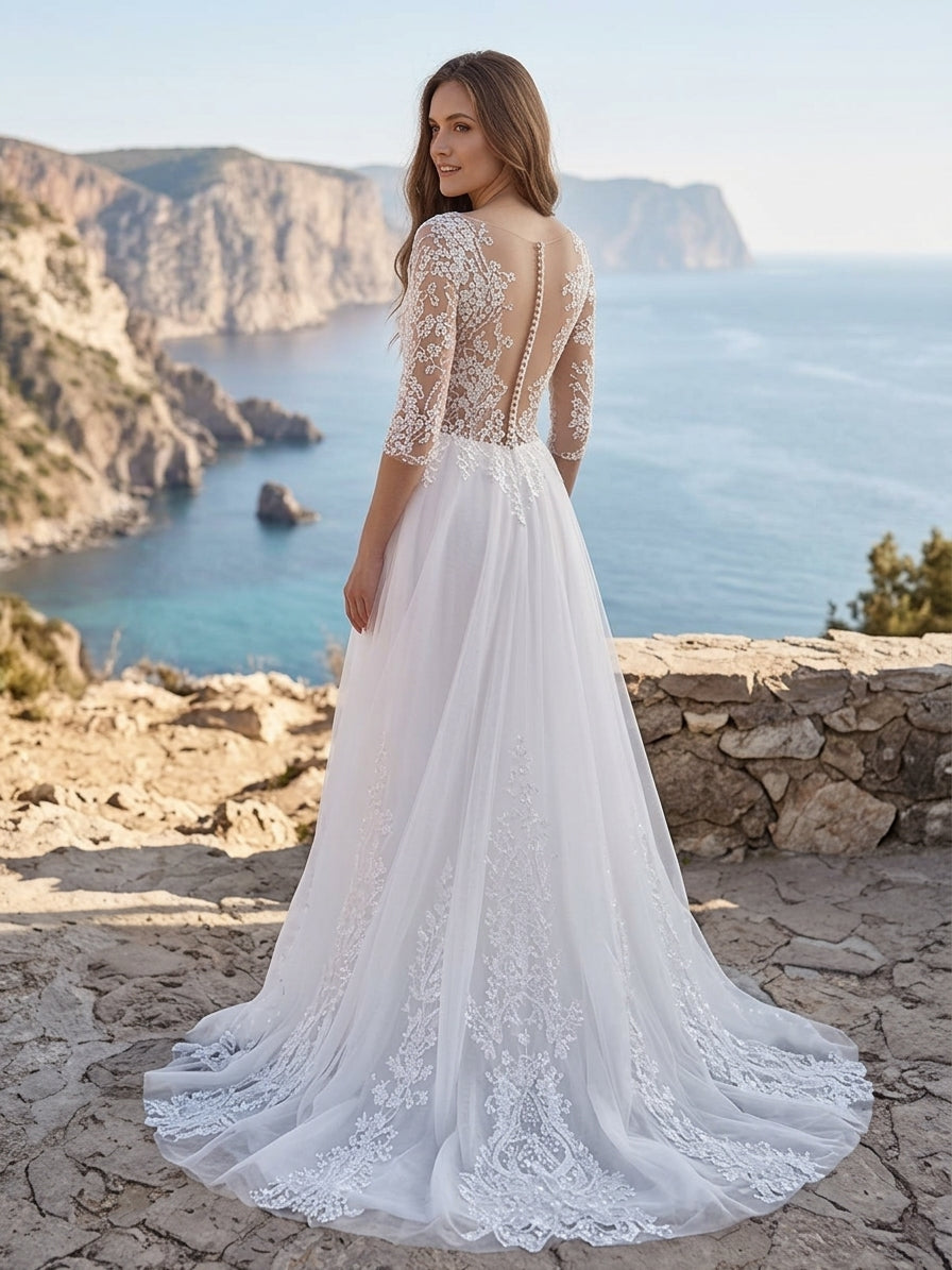 Lacey Bridal Ltd. Clarissa A-line wedding gown with illusion lace back, three-quarter sleeves, and flowing tulle skirt.