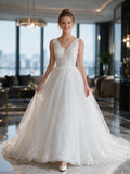 Lacey Bridal Ltd. Cordelia A-line wedding gown with V-neck, lace bodice, and shimmering layered tulle skirt.