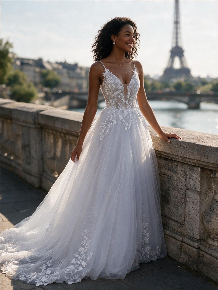 Lacey Bridal Ltd. Corinna A-line wedding gown with lace bodice, plunge neckline, and tulle skirt in Paris.