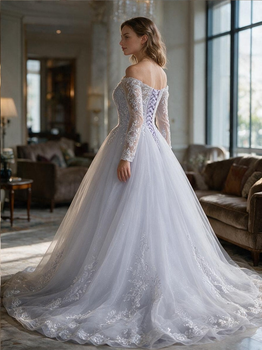 Lacey Bridal Ltd. Cornelia ball gown with off-the-shoulder lace sleeves, corset back, and tulle chapel train.