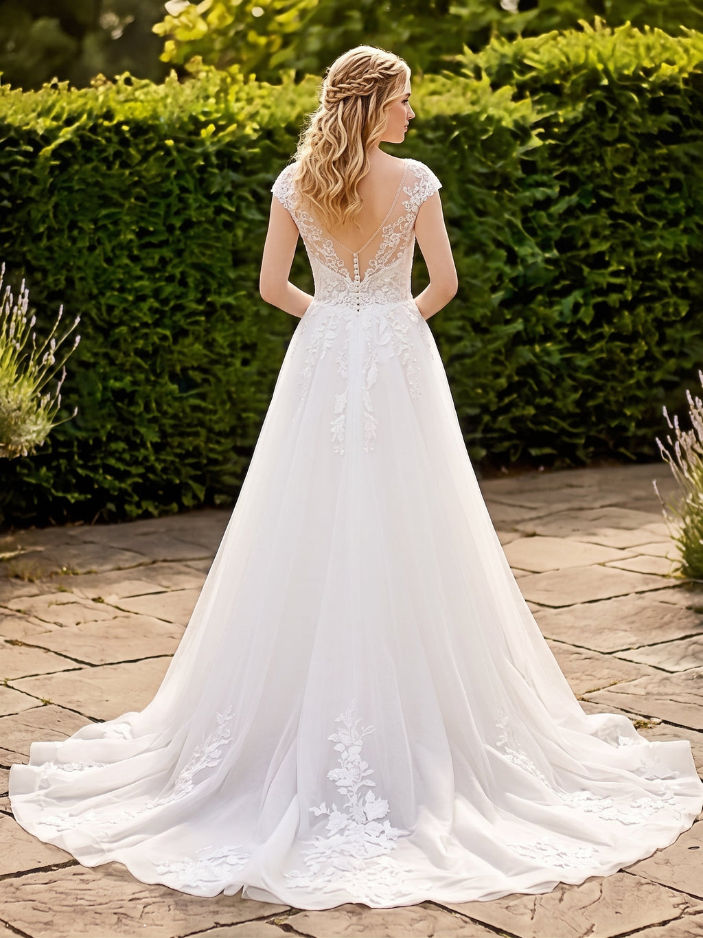Lacey Bridal Ltd. Delphine wedding gown with illusion V-back, lace embroidery, and detachable tulle A-line skirt.