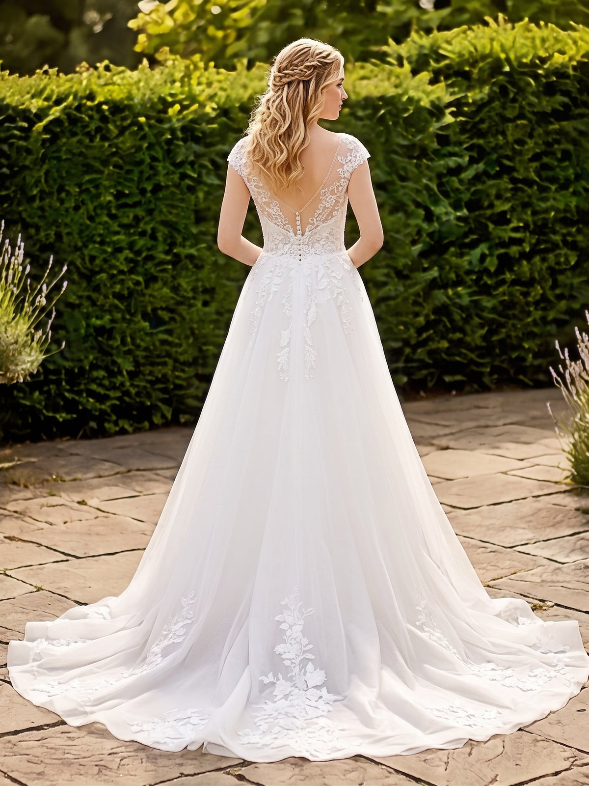 Lacey Bridal Ltd. Delphine wedding gown with illusion V-back, lace embroidery, and detachable tulle A-line skirt.