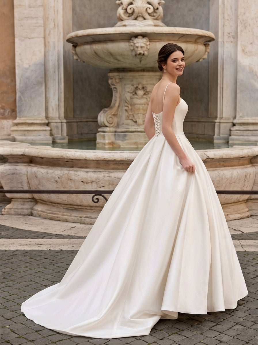 Lacey Bridal Ltd. Dominique satin a-line wedding gown with corset back and sweetheart neckline in a fountain setting.