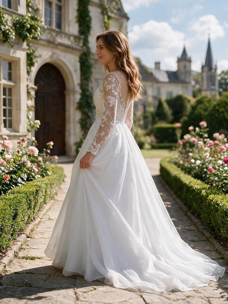 Lacey Bridal Ltd. Eleanor A-line wedding gown with long lace sleeves, pearl buttons, and a flowing chiffon skirt.