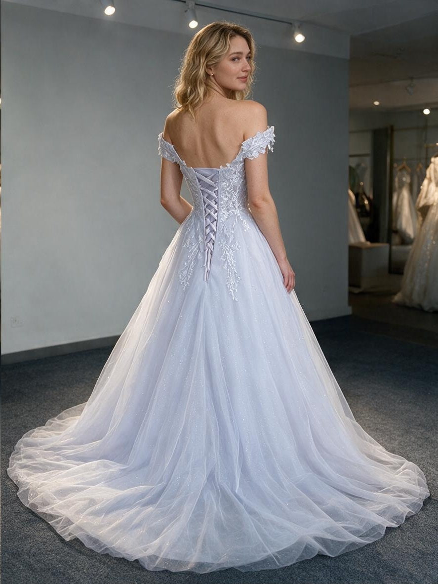 Lacey Bridal Ltd. ELYSIAN A-line wedding dress with off-shoulder botanical lace, tulle skirt, and corset back detail.