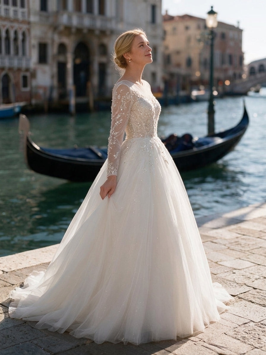 Lacey Bridal Ltd. Eudora ballgown wedding dress with long sheer sleeves, crystal beading, and a full tulle skirt.