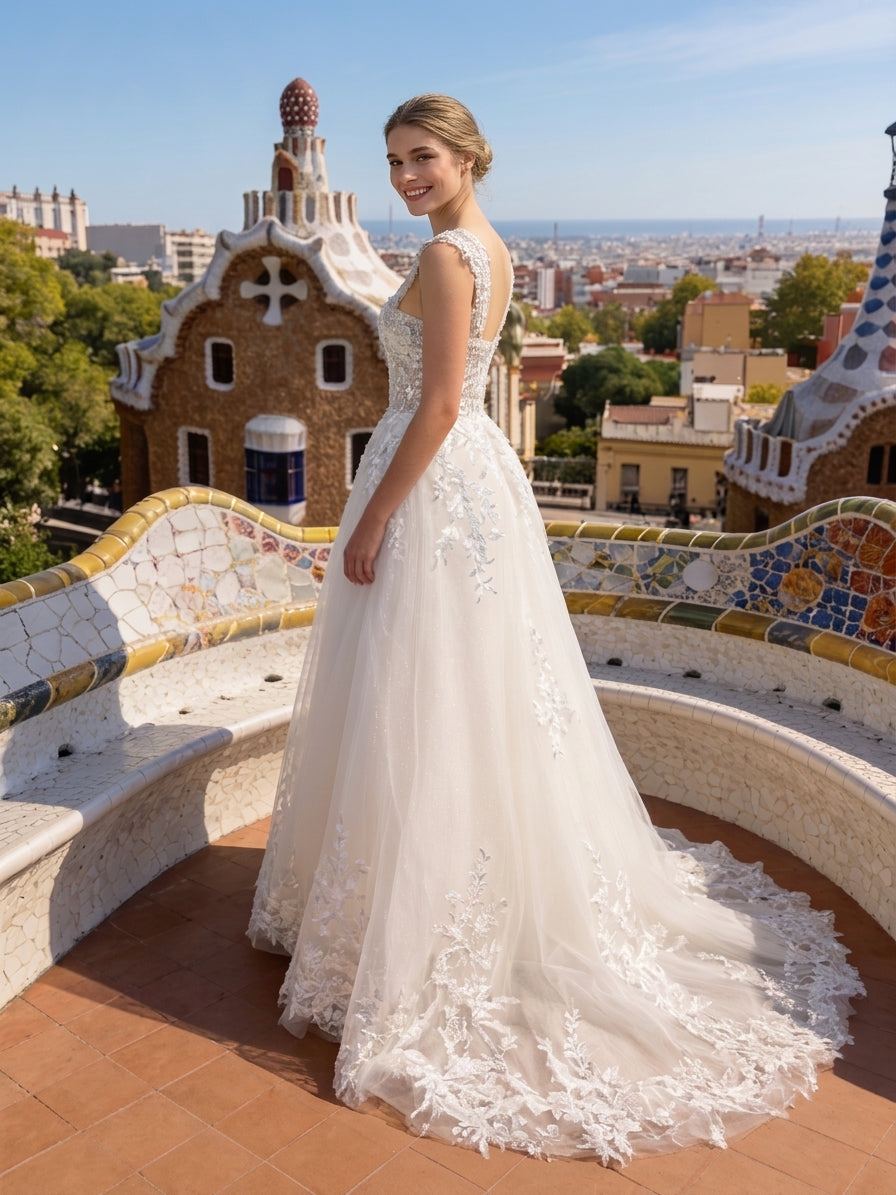 Lacey Bridal Ltd. Evangeline A-line wedding gown with floral lace bodice, tulle skirt, and train in a sunny setting.