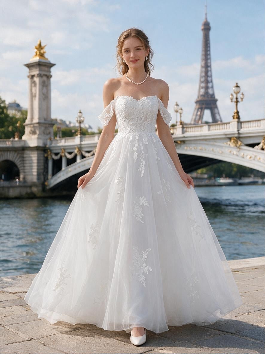 Lacey Bridal Ltd. GISELLE A-line wedding gown with off-the-shoulder lace straps and floral tulle skirt in Paris.