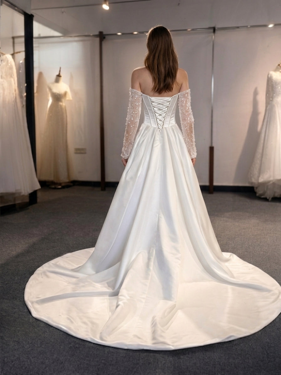 Lacey Bridal Ltd. Helena satin A-line wedding gown with corset back, lace-up detail, and detachable beaded sleeves.