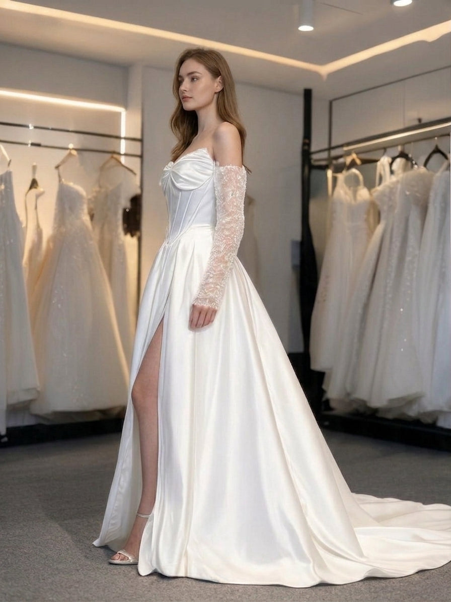 Lacey Bridal Ltd. Helena satin A-line wedding gown with corset bodice, detachable embellished sleeves, and thigh slit.
