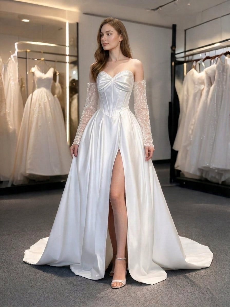 Lacey Bridal Ltd. Helena satin A-line wedding gown with corset bodice, detachable embellished sleeves, and front slit.