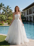 Lacey Bridal Ltd. Henrietta strapless A-line wedding gown with floral tulle skirt and corset bodice by a pool.