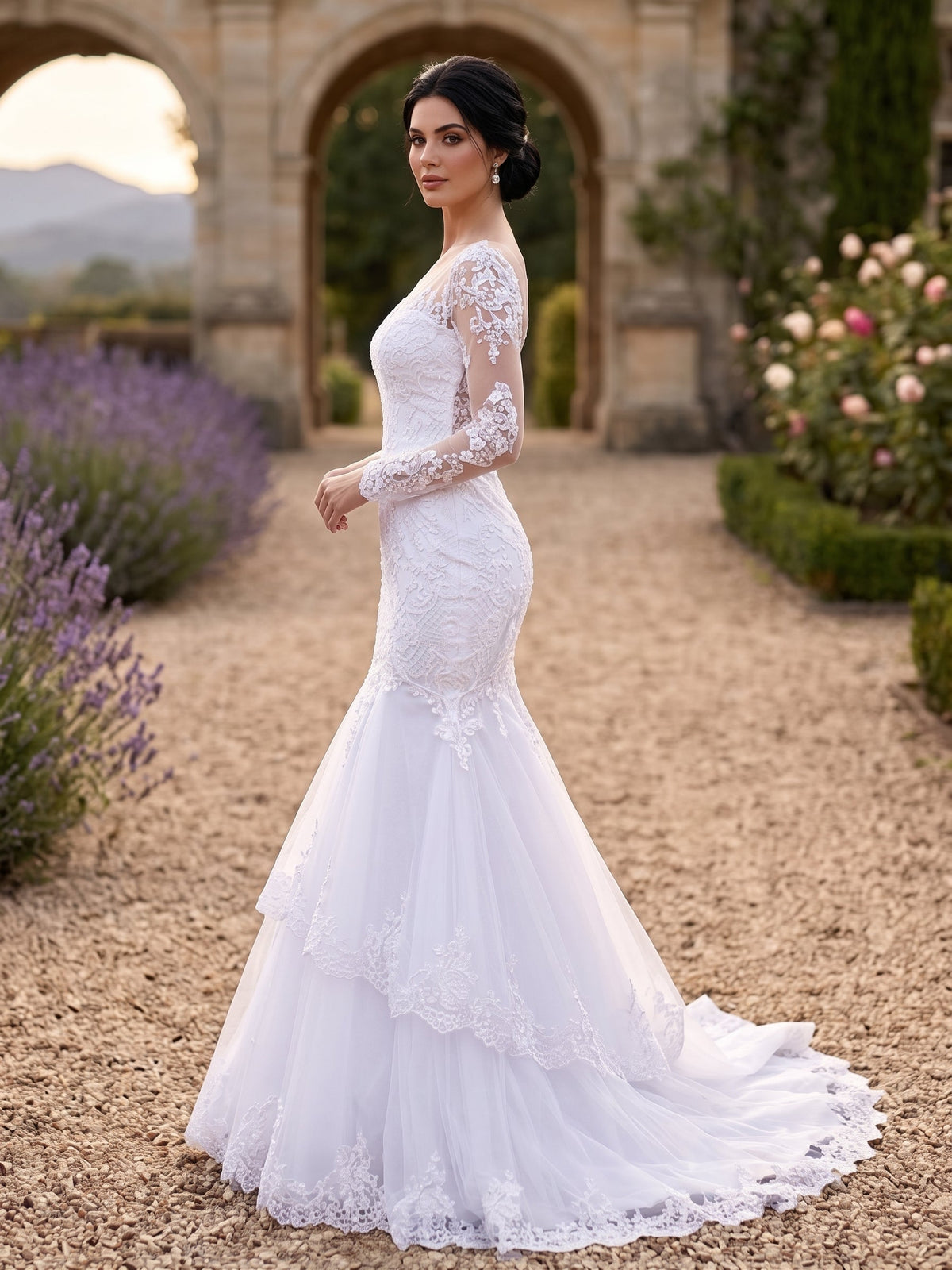 Lacey Bridal Ltd. Hermione mermaid wedding gown with long illusion sleeves, baroque lace, and tiered tulle skirt.