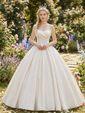 Lacey Bridal Ltd. Hilary satin ballgown with strapless crossover sweetheart neckline and floral embroidery in a garden.