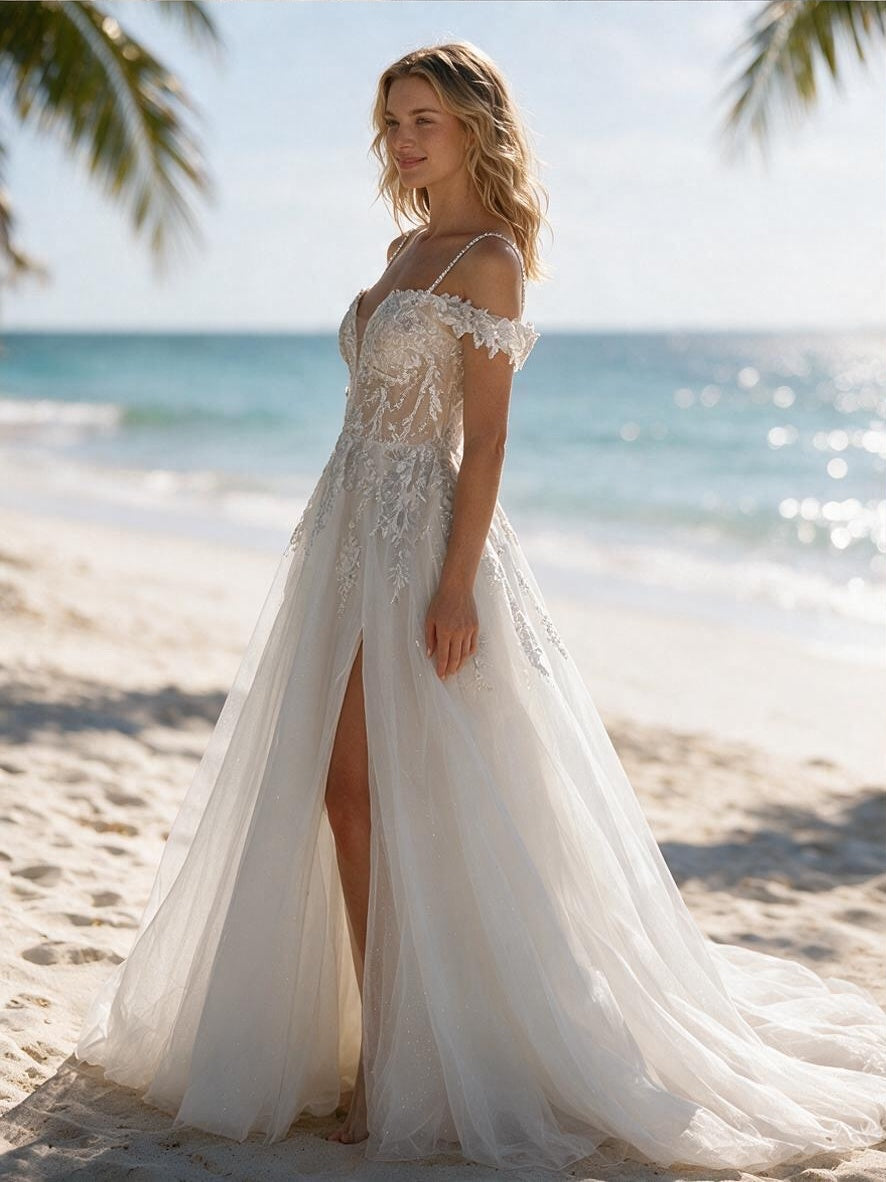 Lacey Bridal Ltd. Isabella A-line wedding gown with floral lace, corset bodice, and thigh-high split on a beach.
