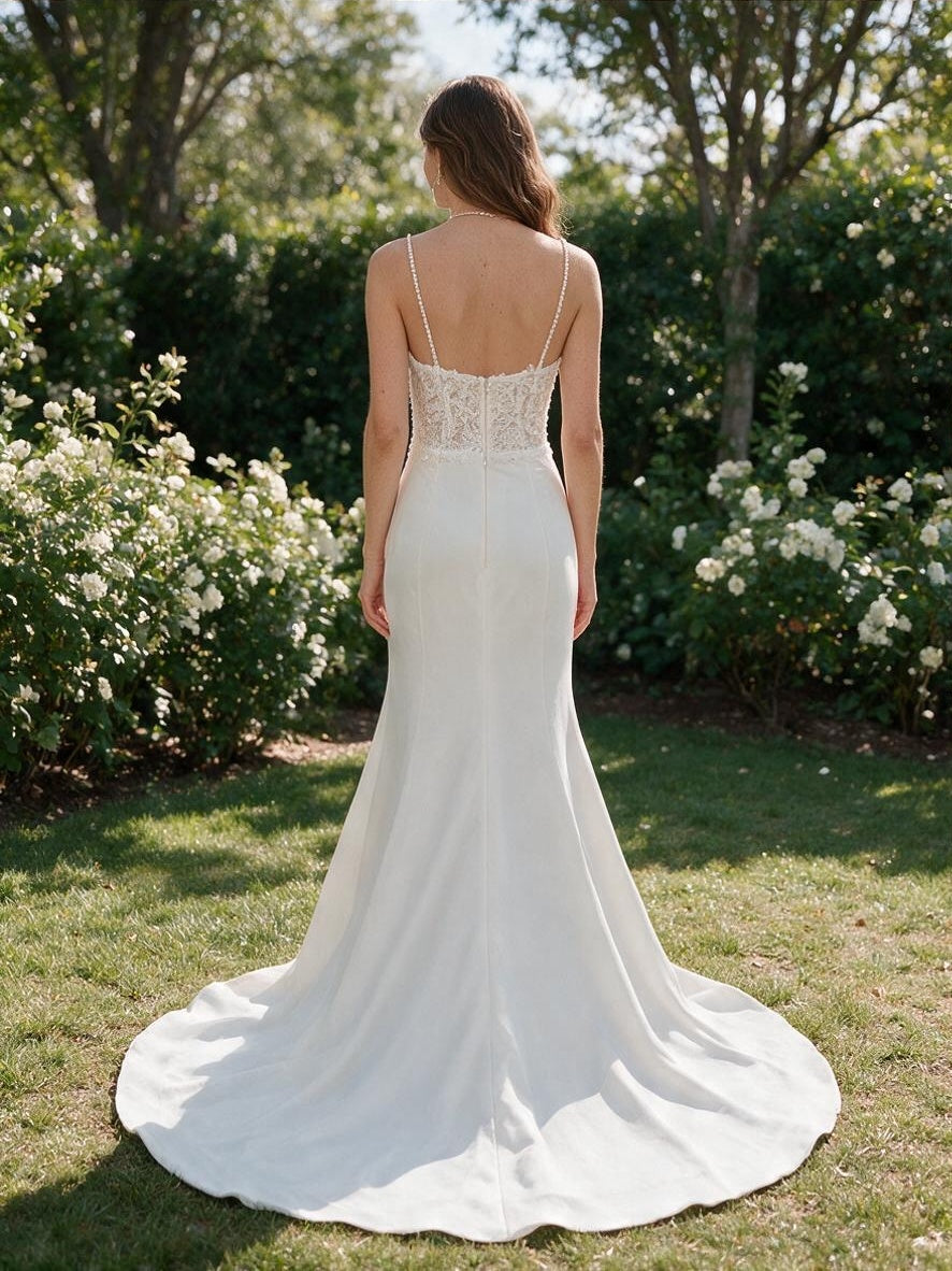 Back view of Lacey Bridal Ltd. Isadora mermaid wedding gown with beaded straps, lace bodice, and ivory crepe train.