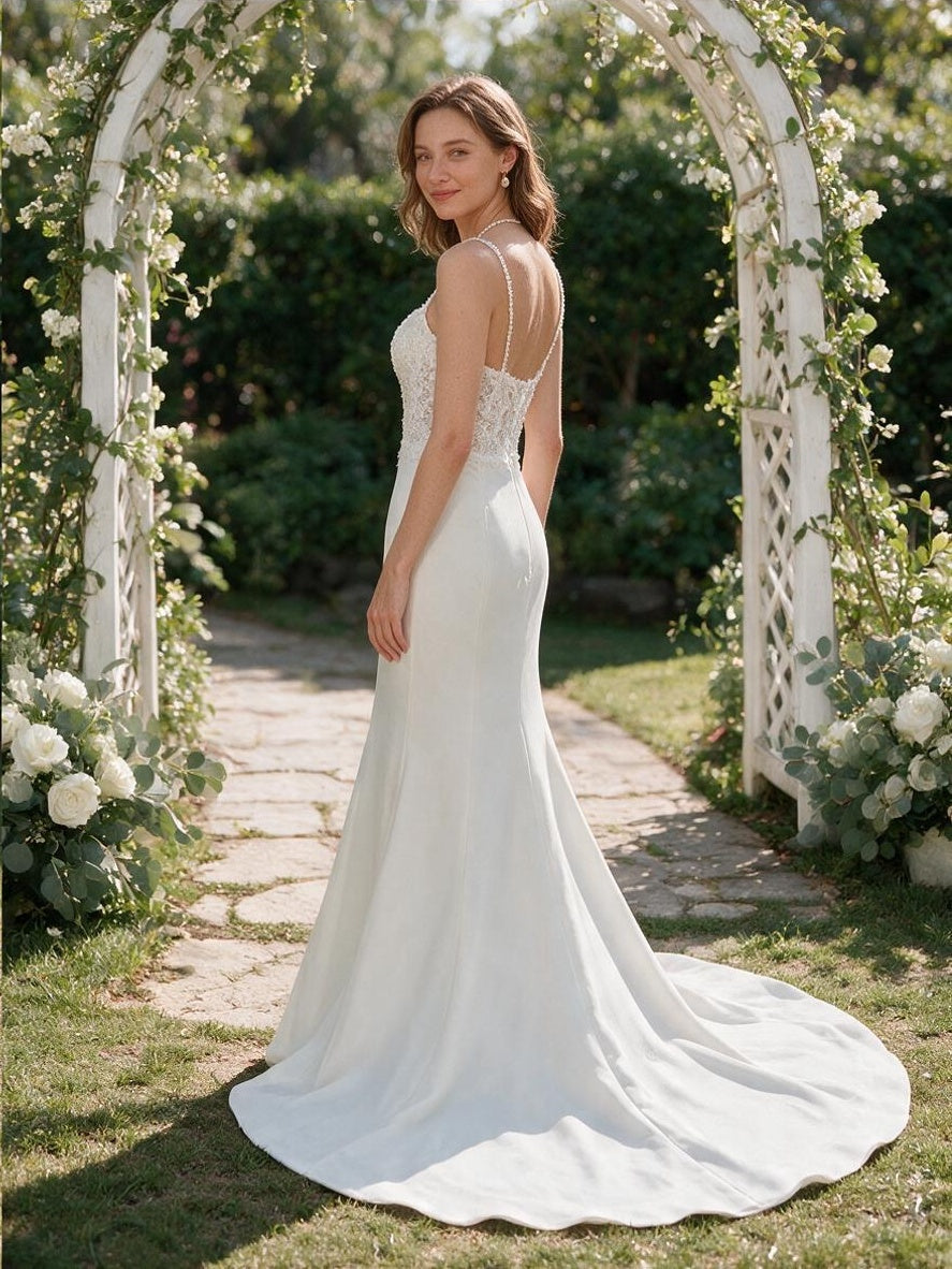 Lacey Bridal Ltd. Isadora mermaid wedding gown with lace corset bodice and ivory crepe skirt in a garden setting.