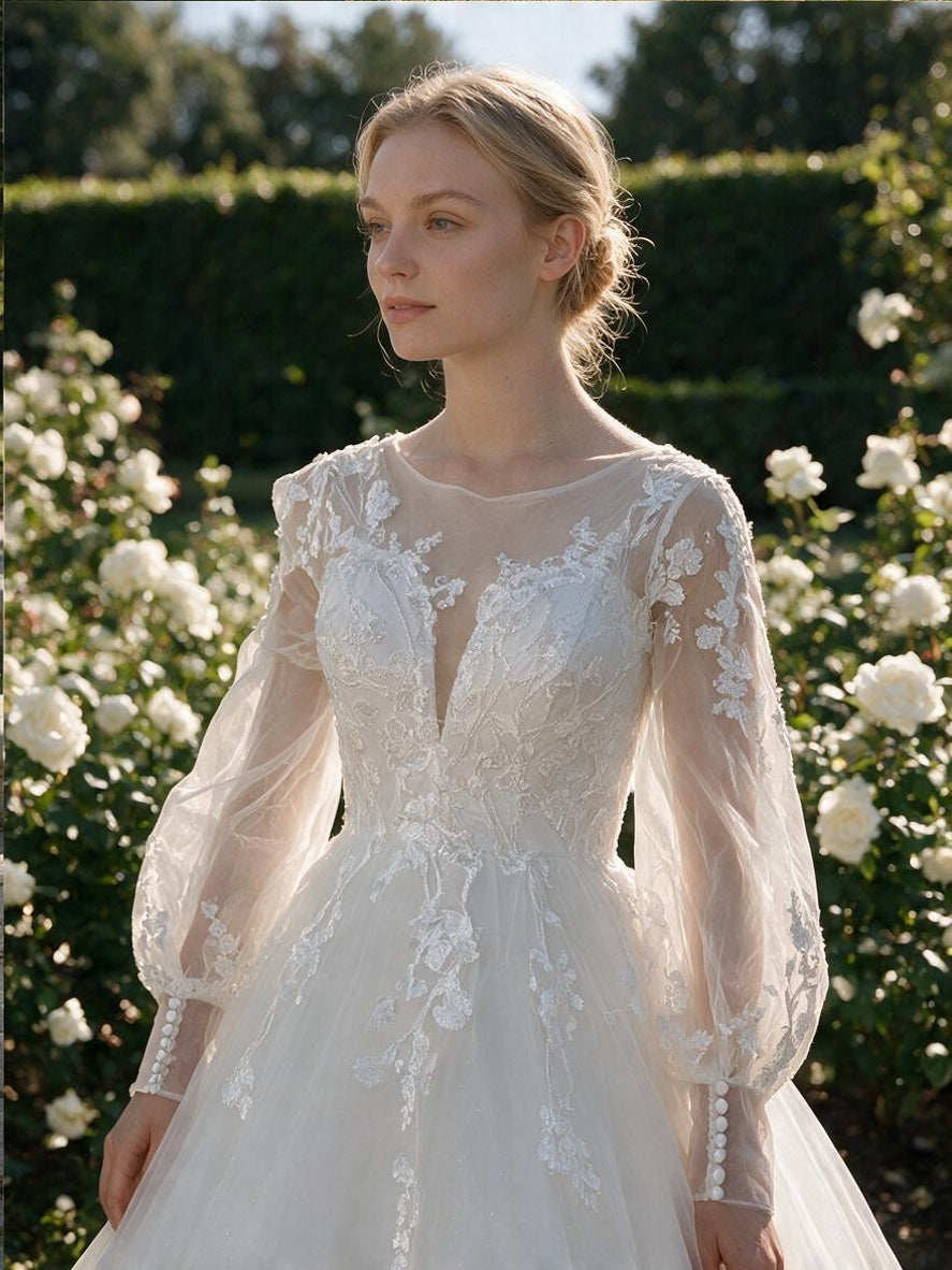 Lacey Bridal Ltd. Juliette A-line wedding gown with sheer bishop sleeves, illusion neckline, and floral lace details.