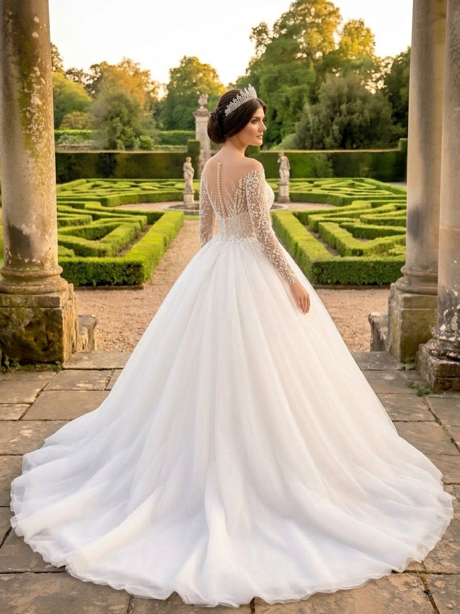 Lacey Bridal Ltd. LAURENTINE ball gown with beaded illusion sleeves, lace bodice, and full tulle skirt in a garden.