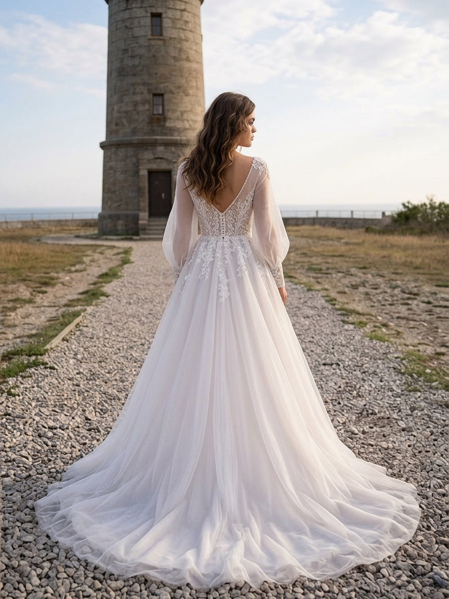 Lacey Bridal Ltd. Lucinda A-line wedding gown with sheer bishop sleeves, floral lace bodice, and flowing tulle skirt.