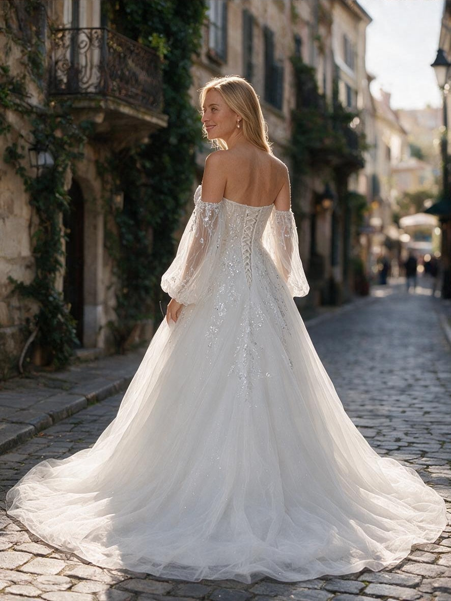 Lacey Bridal Ltd. Marcella A-line wedding gown with floral embroidery, corset back, and sheer bishop sleeves.