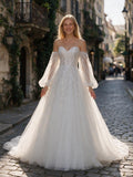 Lacey Bridal Ltd. Marcella A-line wedding gown with floral embroidery, beaded bodice, and sheer bishop sleeves.