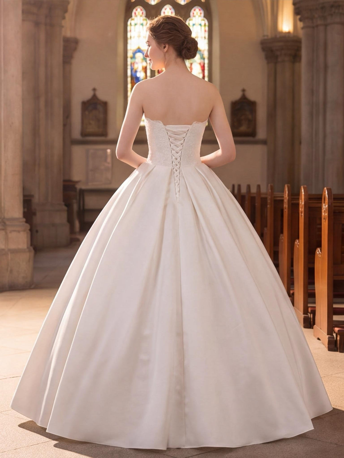 Lacey Bridal Ltd. strapless satin ballgown with lace-up corset back and chapel-length train in a church setting.