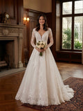 Lacey Bridal Ltd. Melissa A-line wedding gown with long illusion lace sleeves, plunging V-neck, and tulle skirt.