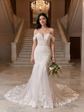 Lacey Bridal Ltd. Mirabelle mermaid wedding gown with off-shoulder lace straps, corset bodice, and tulle train.