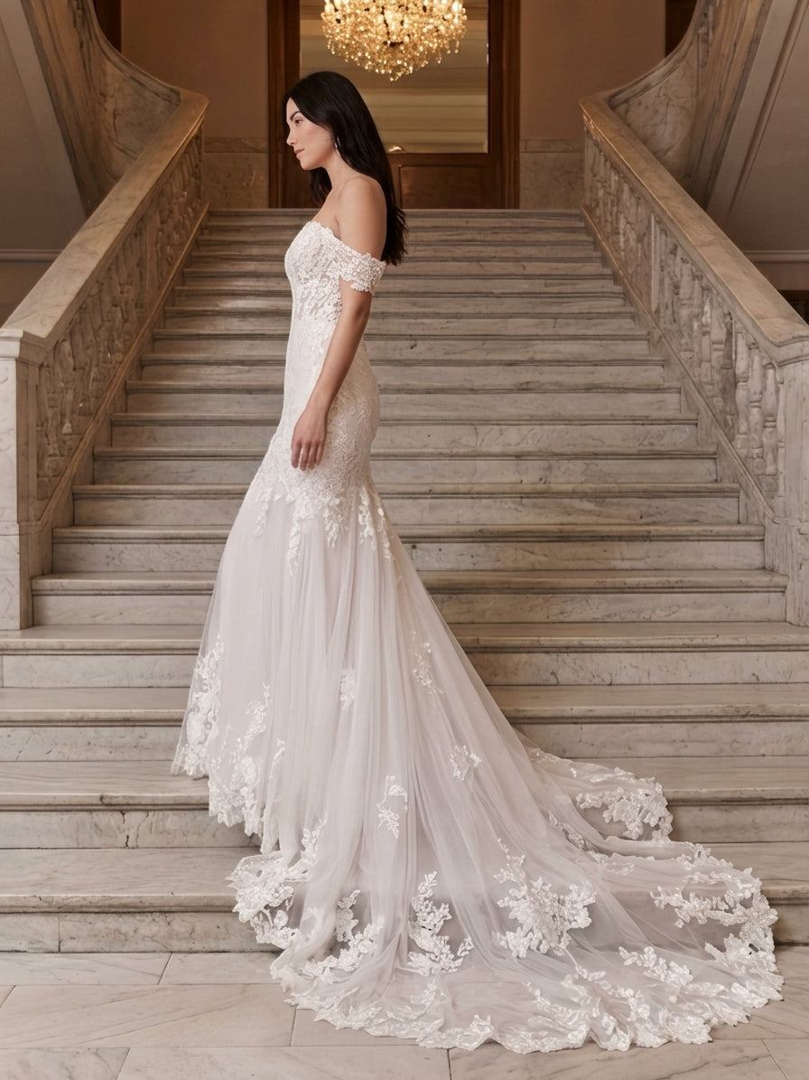 Lacey Bridal Ltd. Mirabelle mermaid wedding gown with off-shoulder lace straps and tulle train on marble staircase