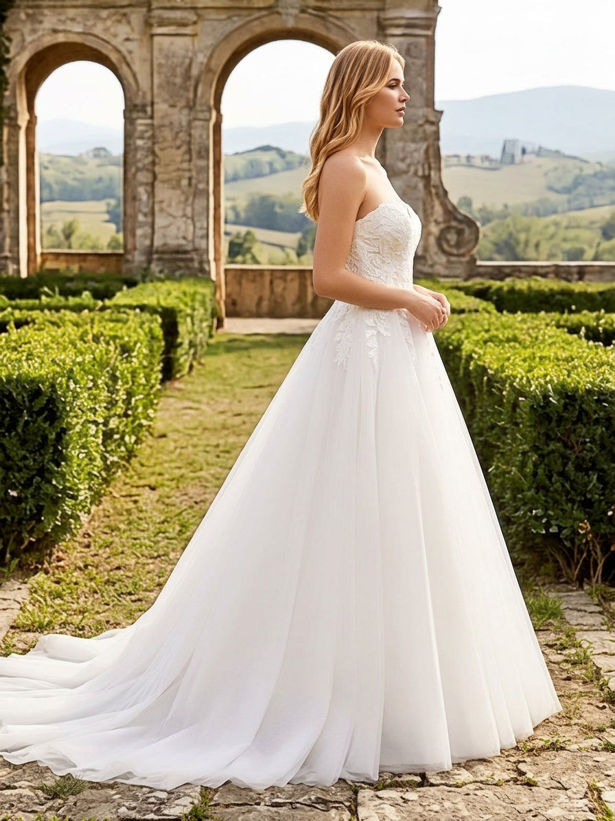 Lacey Bridal Ltd. Natalia strapless A-line wedding gown with floral lace bodice and flowing tulle skirt in a garden