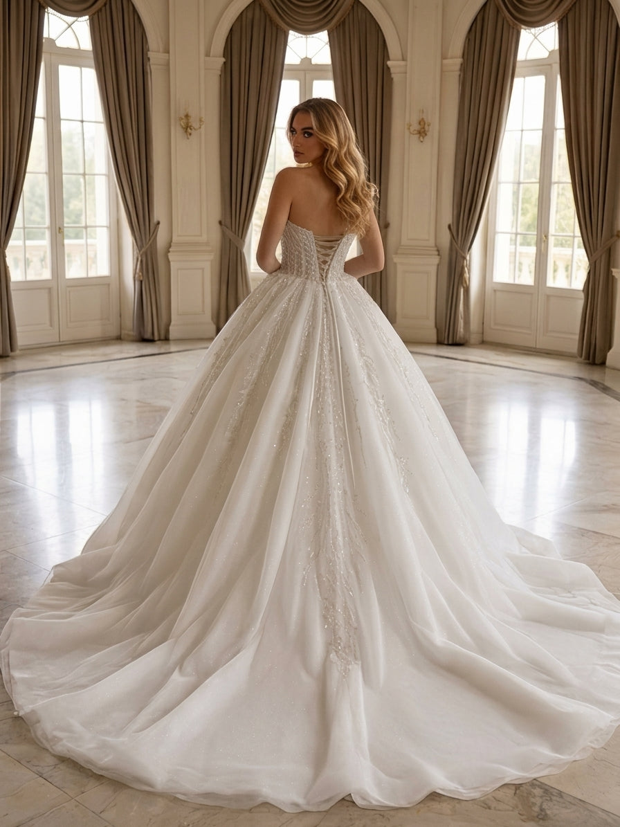 Lacey Bridal Ltd. Nerissa ball gown with a lace-up corset back, beaded bodice, and full tulle skirt with a long train.
