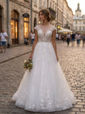 Lacey Bridal Ltd. Opalescence A-line wedding gown with sheer lace bodice and flowing tulle skirt on a city street.