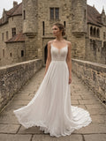 Lacey Bridal Ltd. Ophelia chiffon A-line wedding gown with lace bodice, V-neck, and train at a stone castle.
