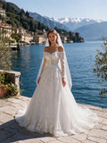Lacey Bridal Ltd. OTTAVIA off-the-shoulder A-line wedding gown with floral lace, long sleeves, and tulle skirt.