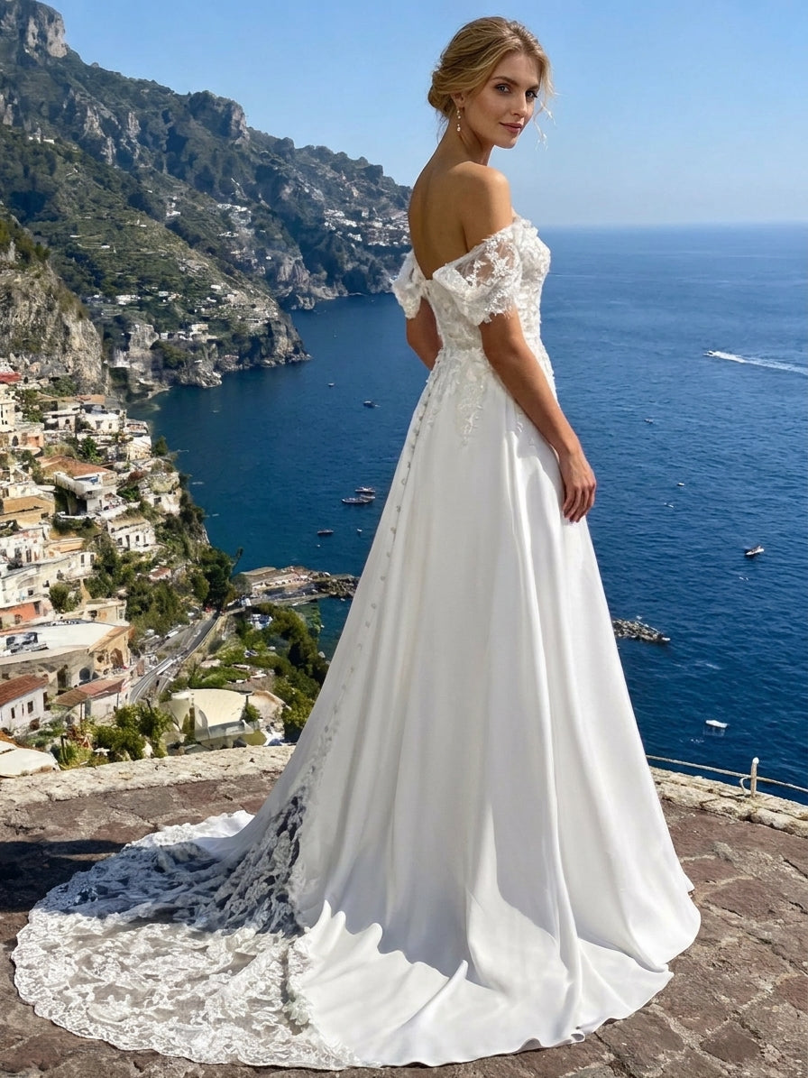 Lacey Bridal Ltd. Penelope A-line wedding dress with off-the-shoulder lace sleeves and illusion lace train on a cliff.